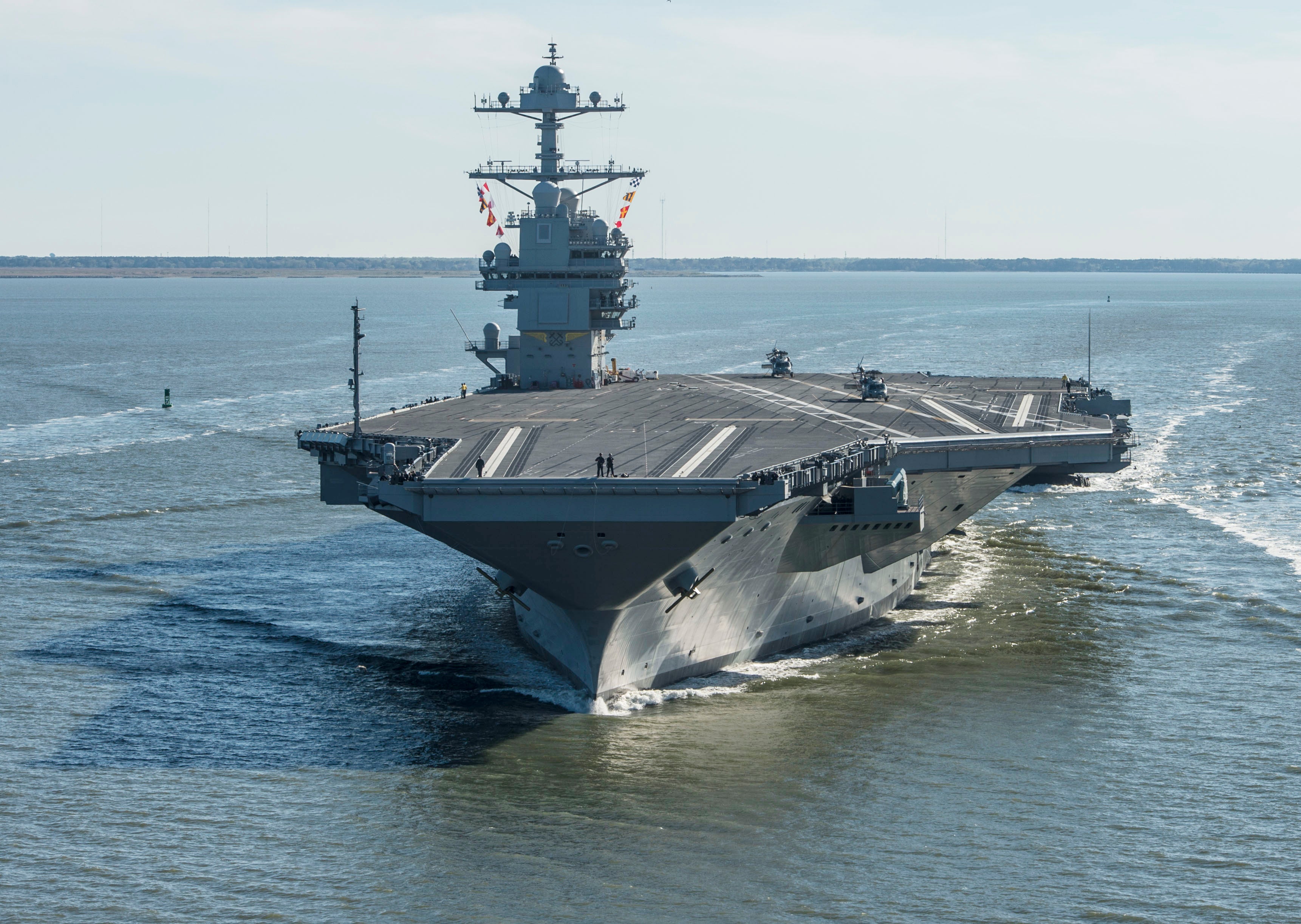 USS Gerald R. Ford returning to port at Naval Station Norfolk, greeted by cheering crowds of military families and supporters