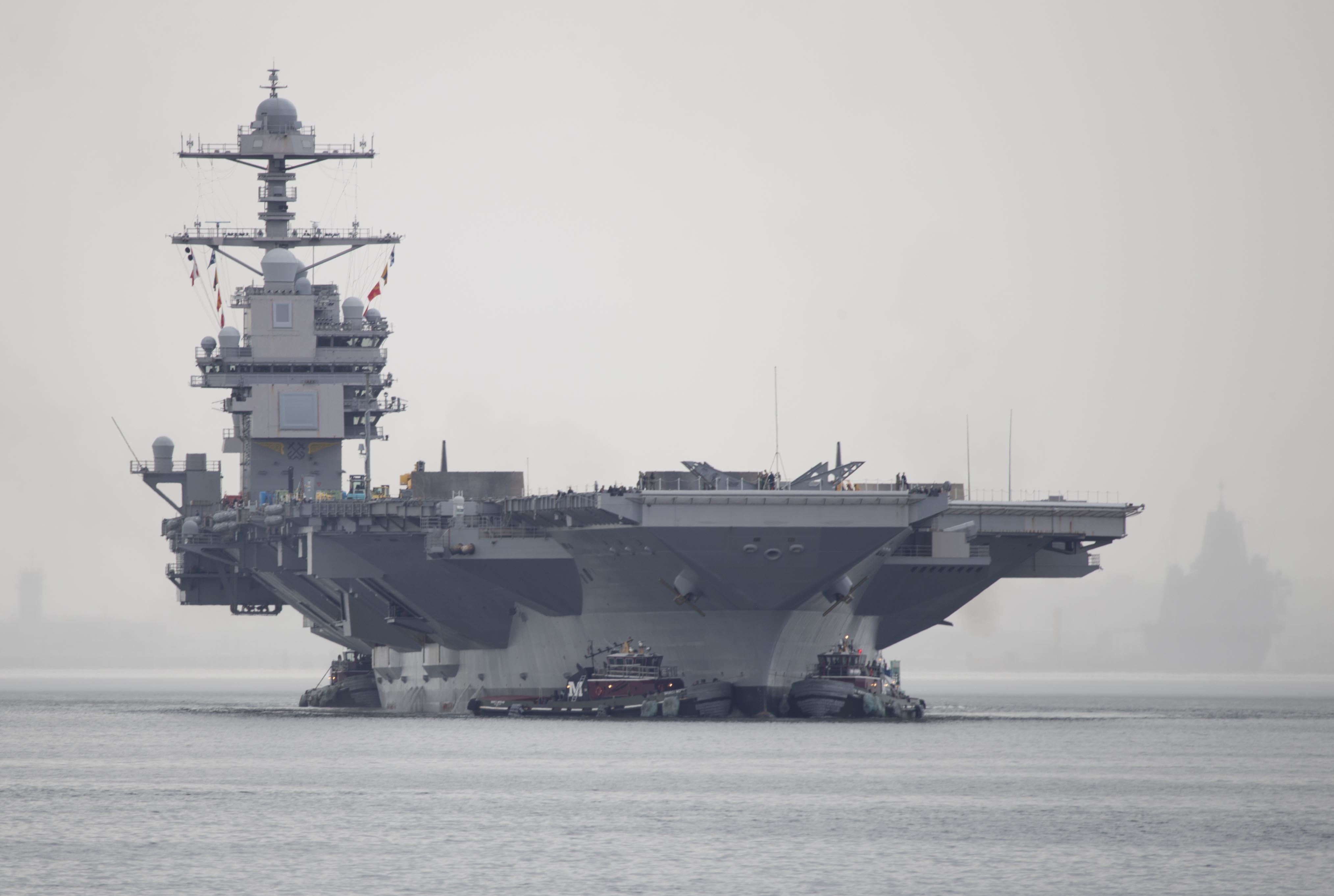 Sailors on the USS Gerald R. Ford conducting flight deck operations, emphasizing teamwork and precision in a high-stakes environment
